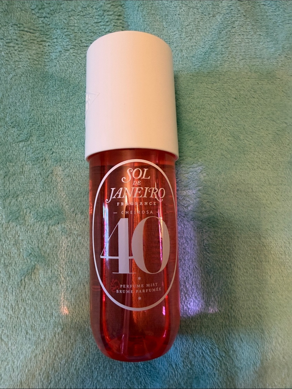 Sol de Janeiro pink perfume mist with white cap and '40' label